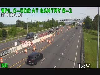Emergency responders are present with cones and barriers on the highway.