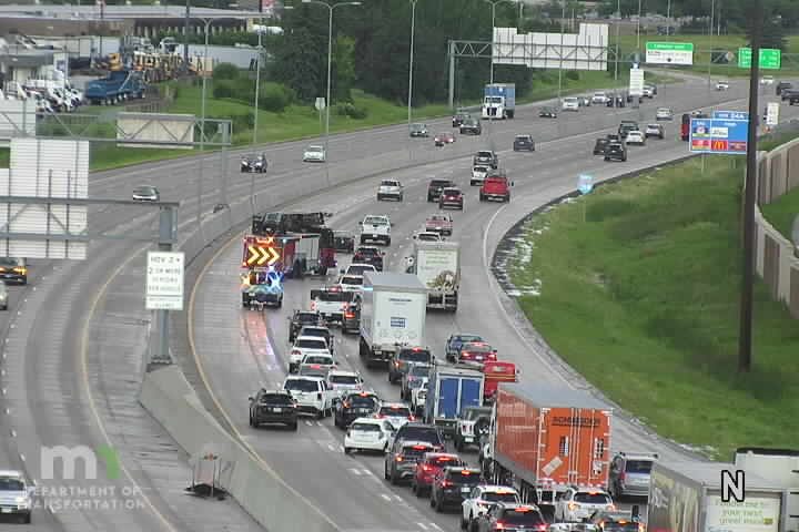 Police car and fire truck with lights on in the left lanes