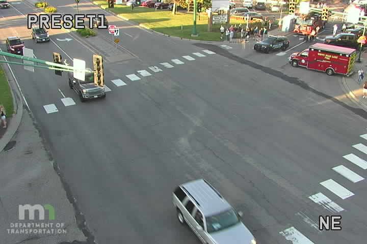 Police car and ambulance with lights on at intersection