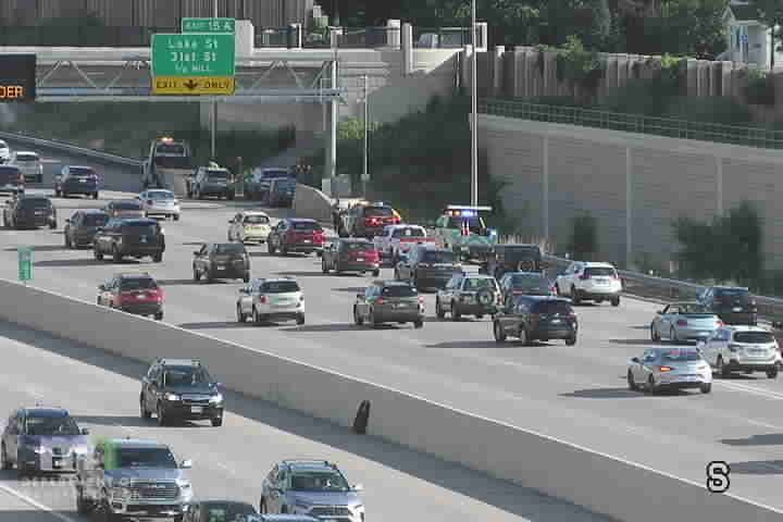 Police car with blue and red lights on the right shoulder