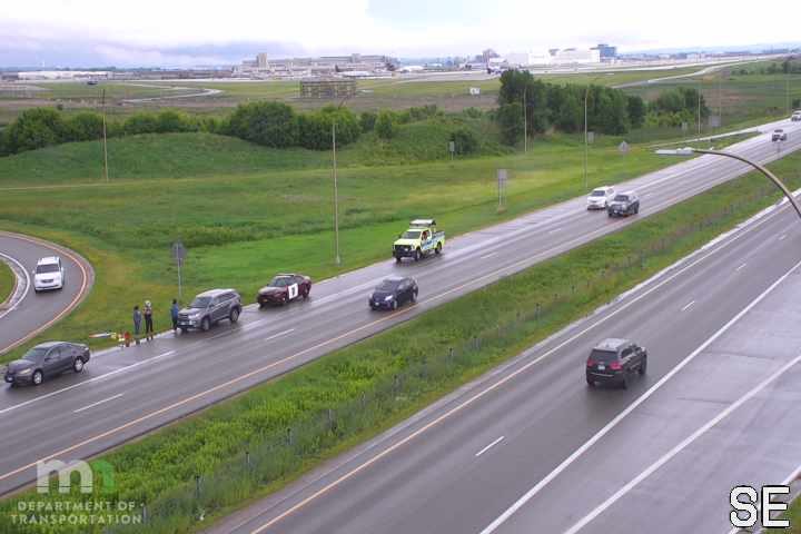 Traffic incident with responders and vehicles on the shoulder.