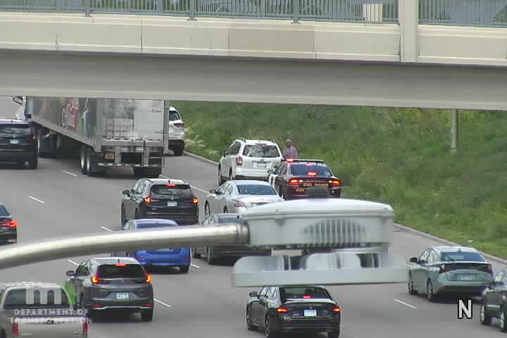 State Trooper vehicle with lights on in the right lane