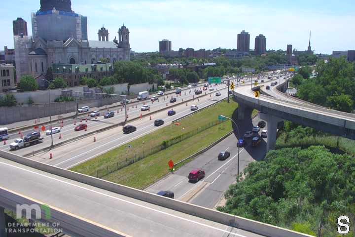 Police car with flashing lights on the shoulder of the highway.