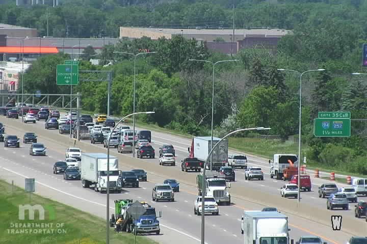 Road work crew with truck and cones on the shoulder of the highway.