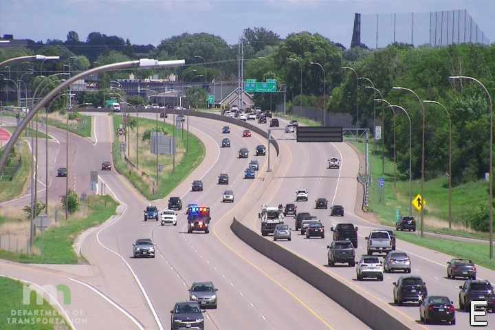 Ambulance with lights on in the left lane
