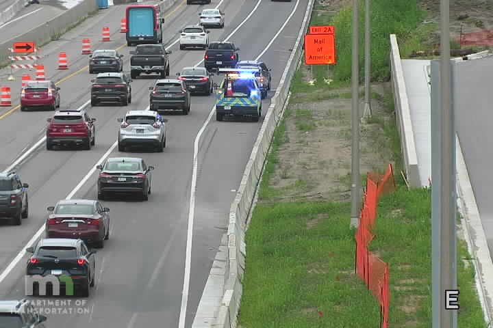 Police car with blue and red lights on the roadway