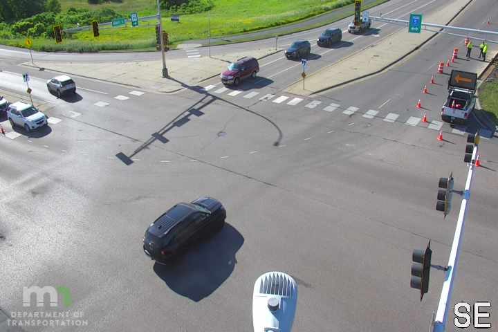 Traffic cones and personnel indicate a responder incident on the roadway.