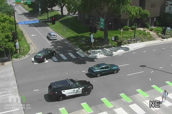 Police car present at intersection with a pedestrian crossing.