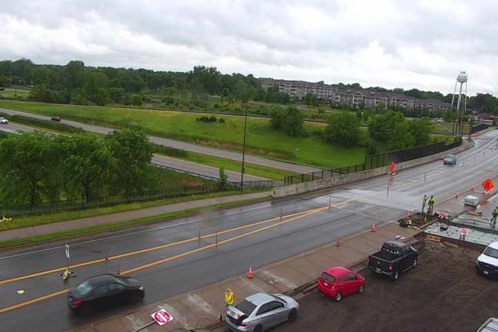 Construction workers and equipment on the roadway indicate a responder/work zone incident.