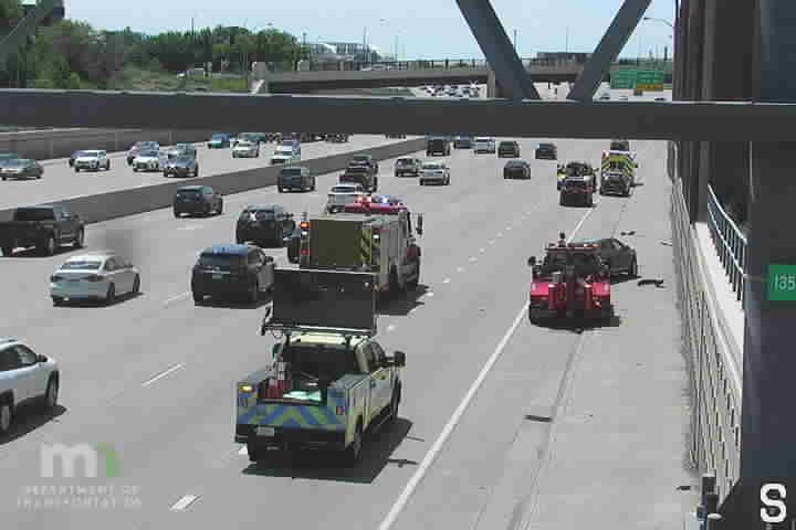 Emergency responders and tow truck on the highway assisting with a vehicle.