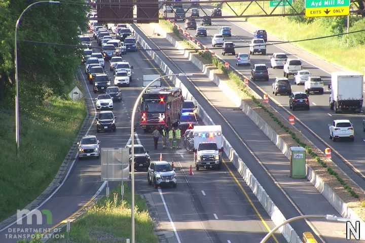 Emergency responders and vehicles are present on the highway, indicating an incident.