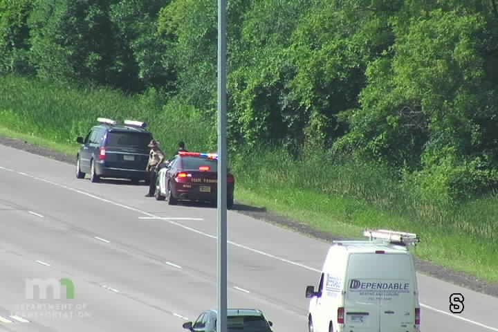 Police car with lights on the shoulder