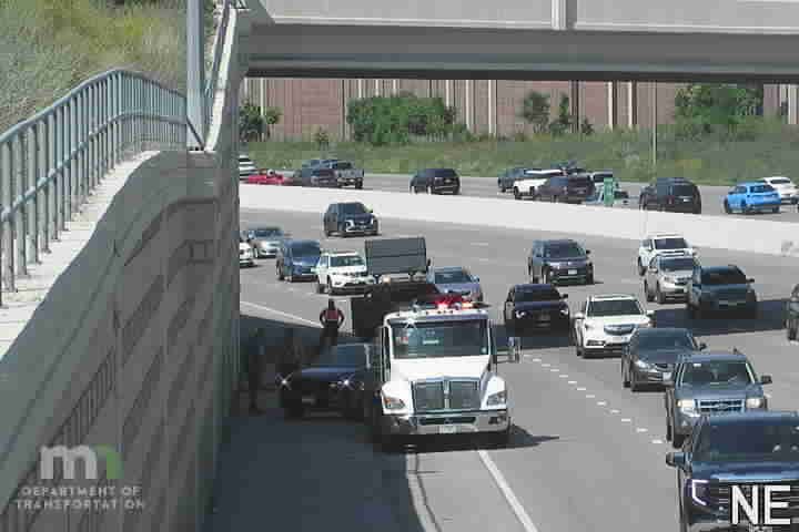 Tow truck with red and white lights on the right lane