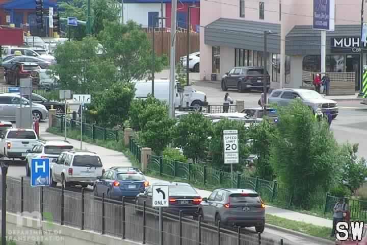 Police and other responders are present on the roadway with vehicles and near the roadway.