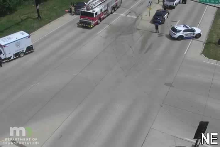 Emergency responders on scene with fire truck, ambulance, and police cars.