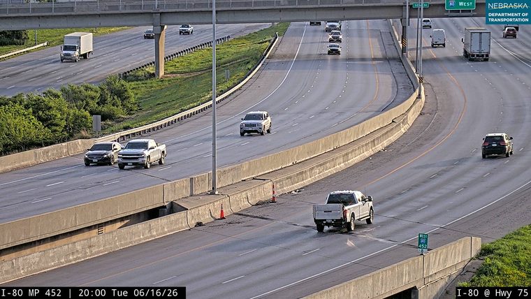 Debris scattered on the roadway, with traffic cones present.