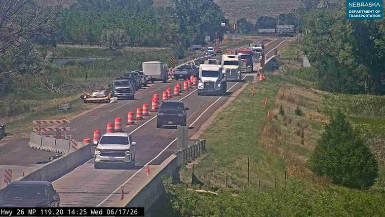 Debris on the roadway causing traffic backup and lane closure.