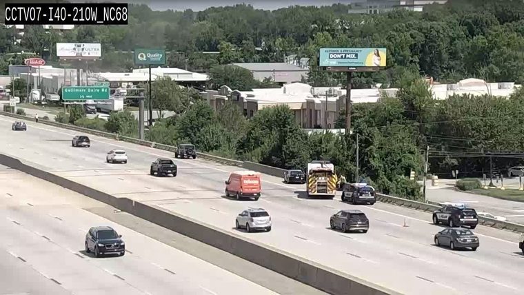 Multiple police cars and a fire truck on the right shoulder
