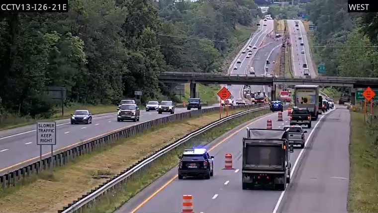 Police car with blue flashing lights in the right lane