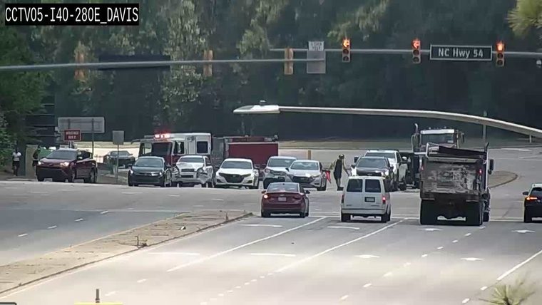 Emergency responders and vehicles are present at an intersection with traffic disruption.