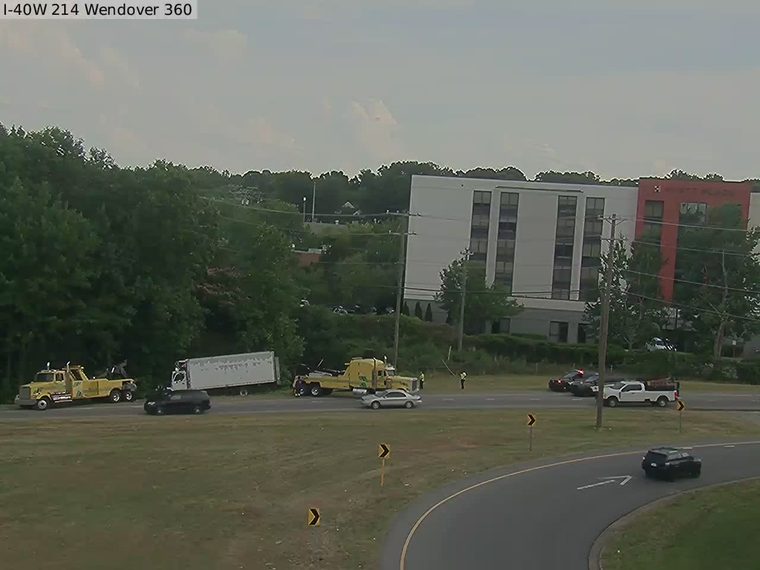 Police car and tow trucks on the right shoulder