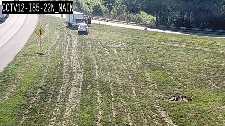 Debris visible on the grassy shoulder of the highway.