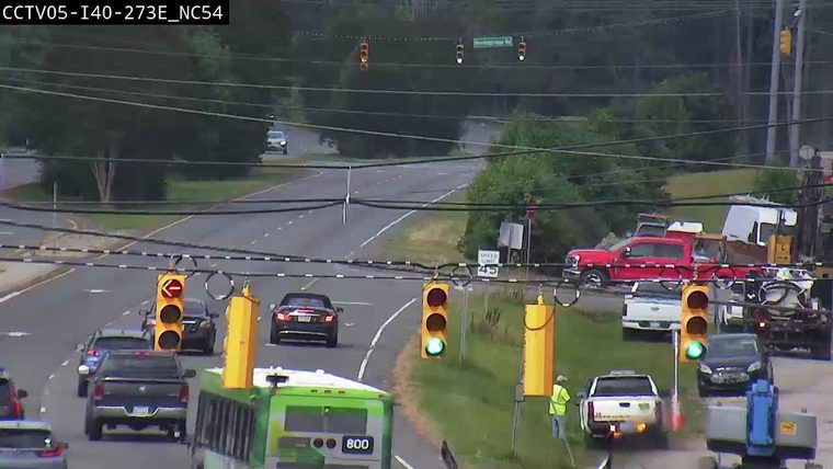 Emergency responders and vehicles are present at the roadside.