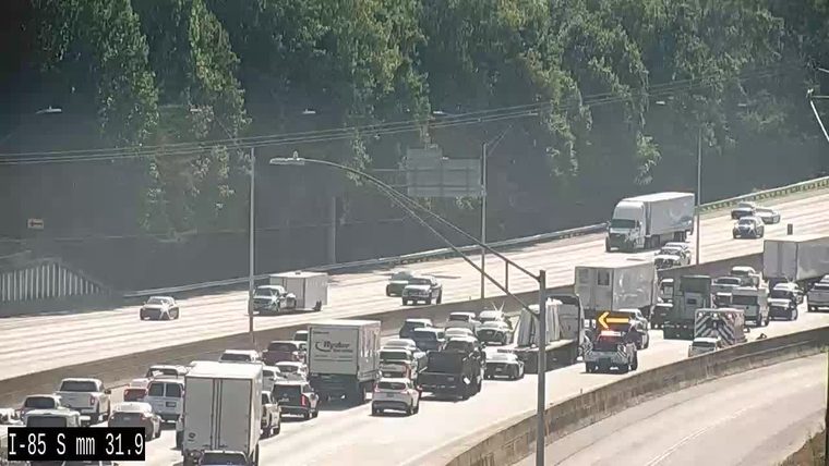 Tow truck with flashing lights in the right lane