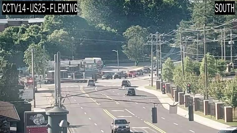 Emergency responders with lights visible on the left side of the roadway.