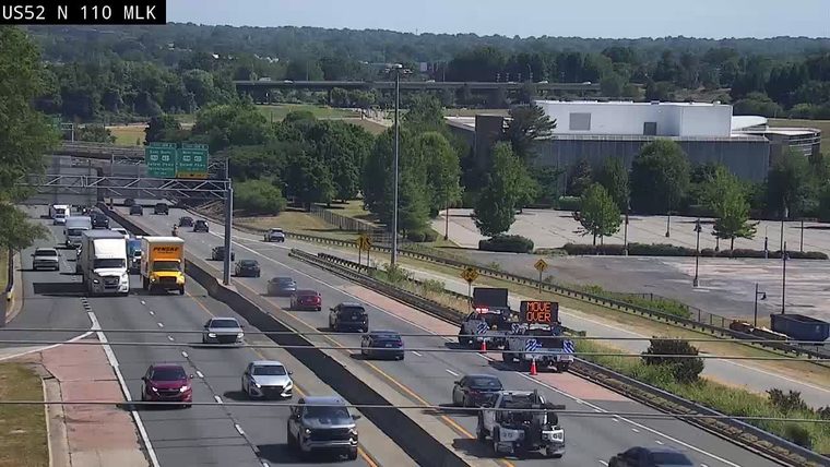 Traffic incident with a "MOVE OVER" sign and emergency vehicle on the highway.