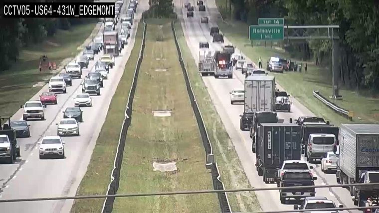 Police car and several people on the right shoulder