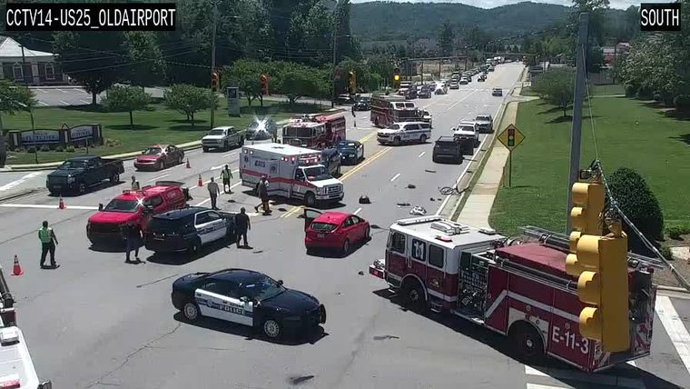 Multiple emergency vehicles and personnel in the roadway