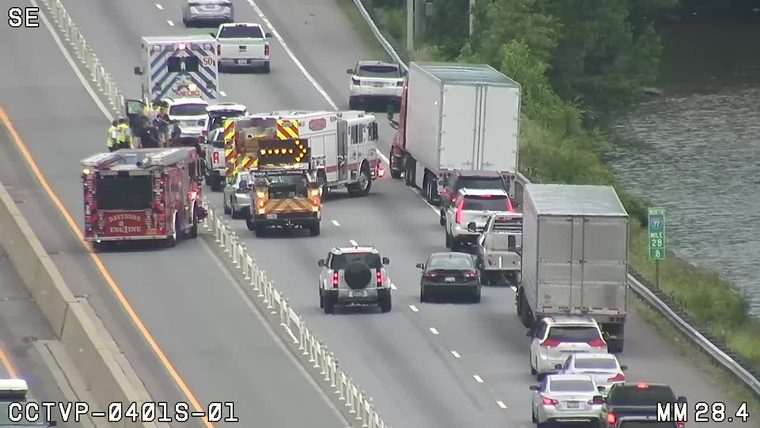 Multiple emergency vehicles and personnel on the roadway