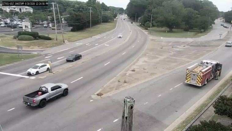 Fire truck on the side of the road with a person visible.