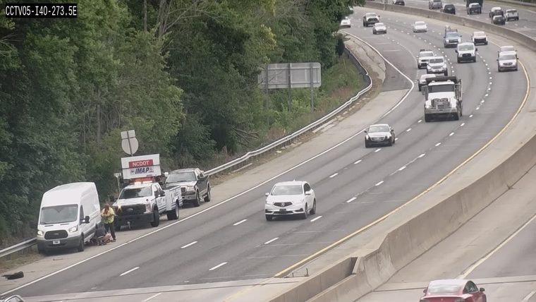 NCDOT responders assisting a vehicle on the shoulder of the highway.