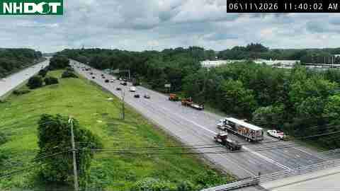 Emergency vehicles and tow trucks are present on the highway.