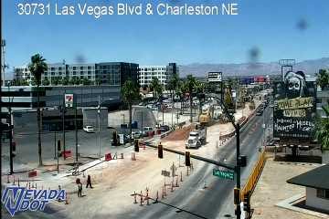 Active construction zone with cones, barricades, and heavy machinery blocking lanes on Las Vegas Blvd