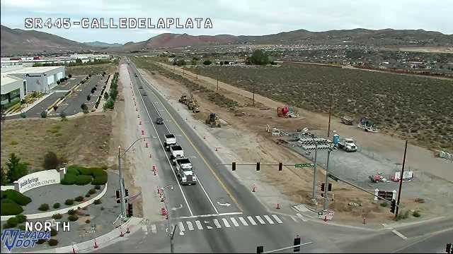 Construction equipment and workers in the right lane