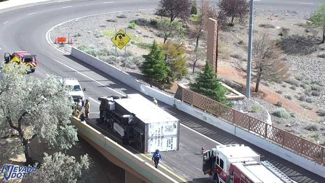 Overturned semi-truck in the right lane with responders present