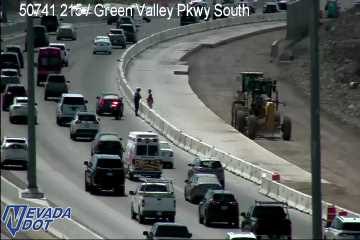 Construction equipment and workers on the right shoulder