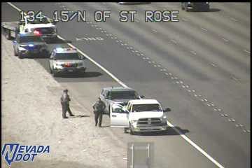 Police car and tow truck with lights on the shoulder