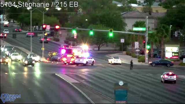 Ambulance and police car with lights on in the intersection