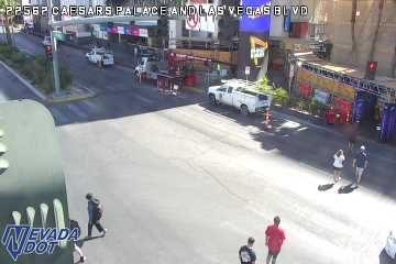 Construction vehicles, cones, and equipment blocking the right side of the roadway