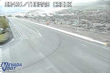 Construction cones and two workers in the right lane