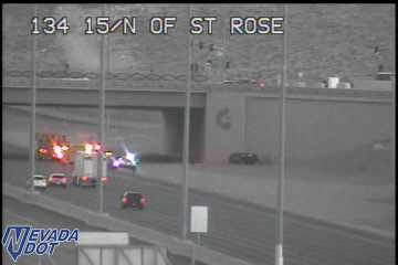 Multiple emergency vehicles with lights on in the left lanes