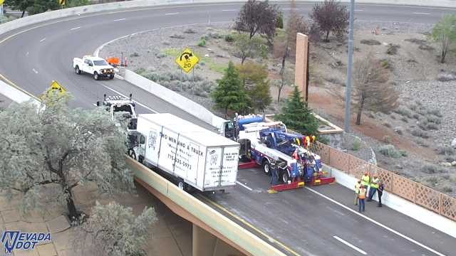 Tow truck assisting a box truck on the right lane