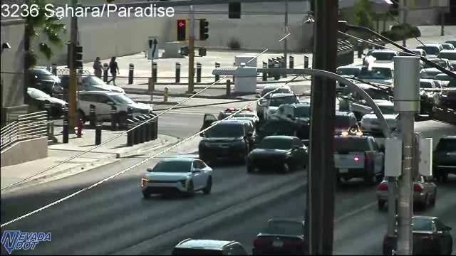 Police car with hazard lights on in the middle lane