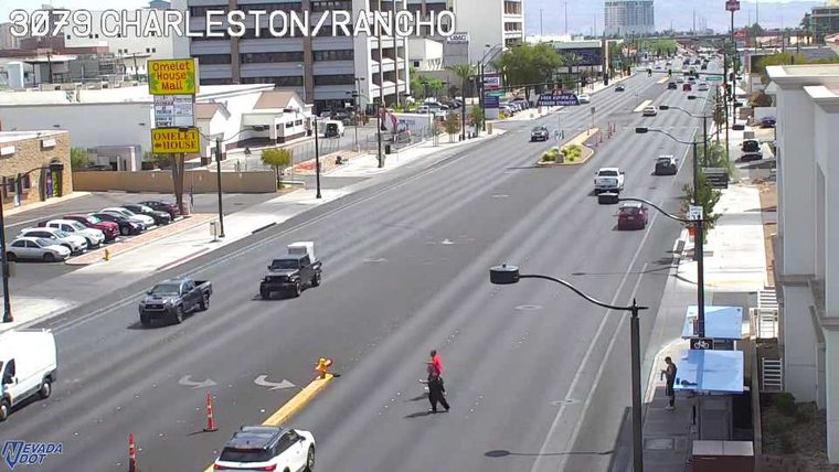 Person crossing the roadway in the middle of the street