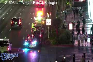 Police car with red and blue lights on the right shoulder