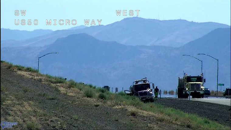Truck off the travel lanes with a person standing nearby